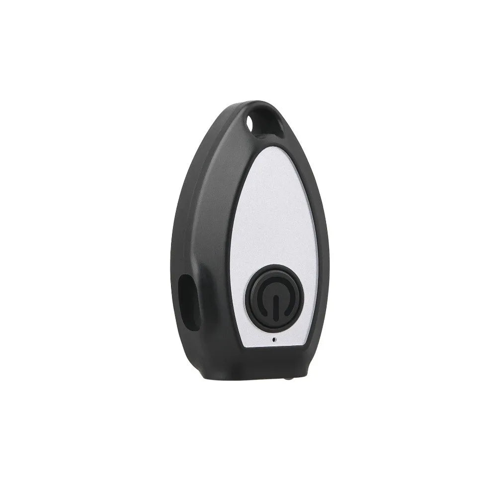 A black and white handheld ultrasonic dog bark deterrent device with a round button.