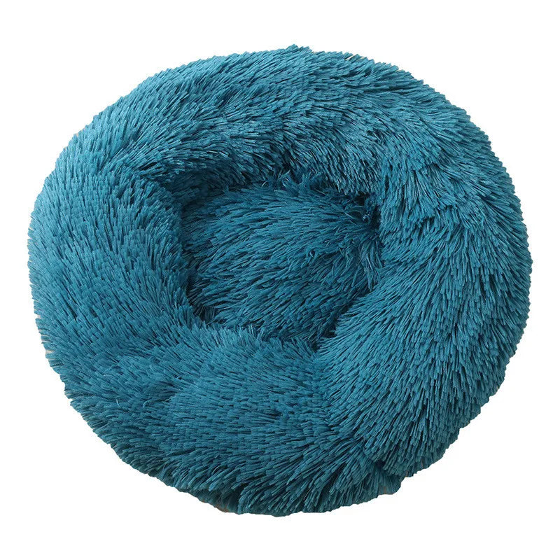 A round, teal blue plush pet bed for dogs and cats with a fluffy texture.