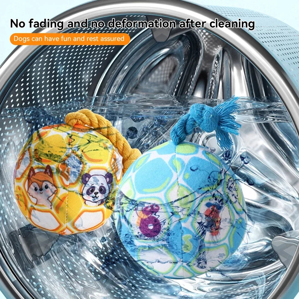 A blue and yellow plush rope ball dog toy is shown inside a stainless steel pet bowl.