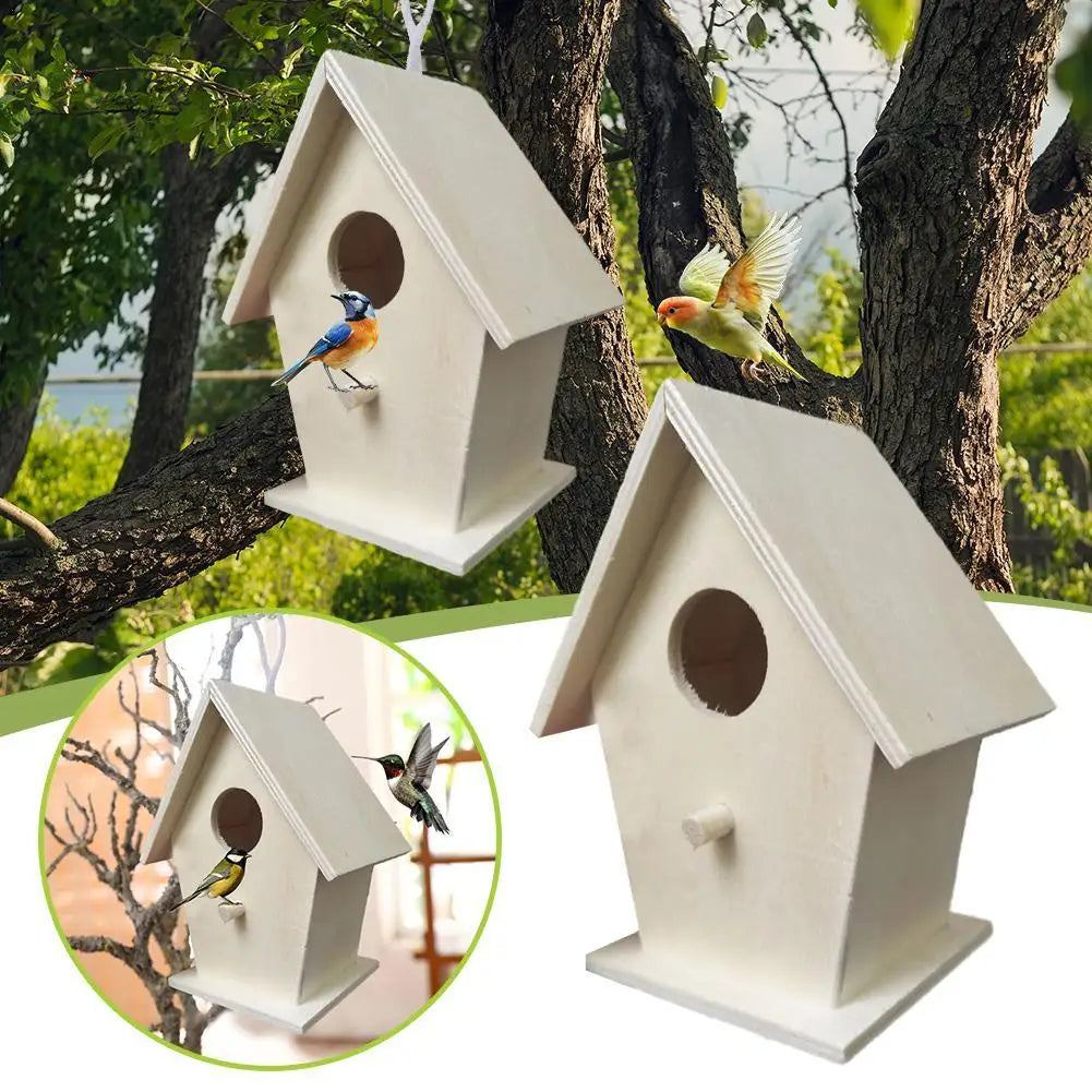 A white wooden wall-mounted bird house is shown with birds perched on it, set against a tree trunk and foliage.