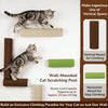 A tabby kitten is climbing a vertical wooden cat scratching post mounted on a white wall.