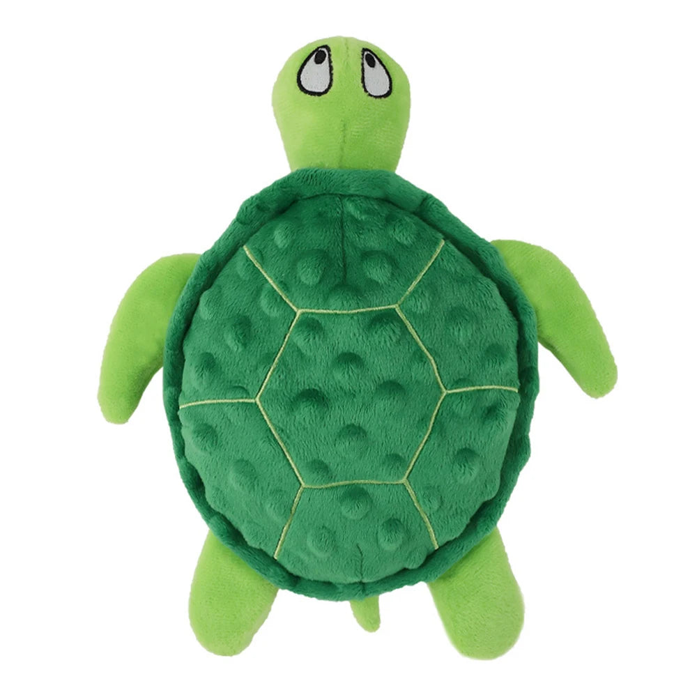 A plush green toy shaped like a turtle with a textured shell and friendly face.