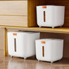 A white airtight pet food storage bucket with an orange lid and a brown pet food item visible inside, placed on a wooden shel