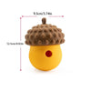 A yellow slow feeder puzzle toy shaped like a pineapple with a textured top and a hole.