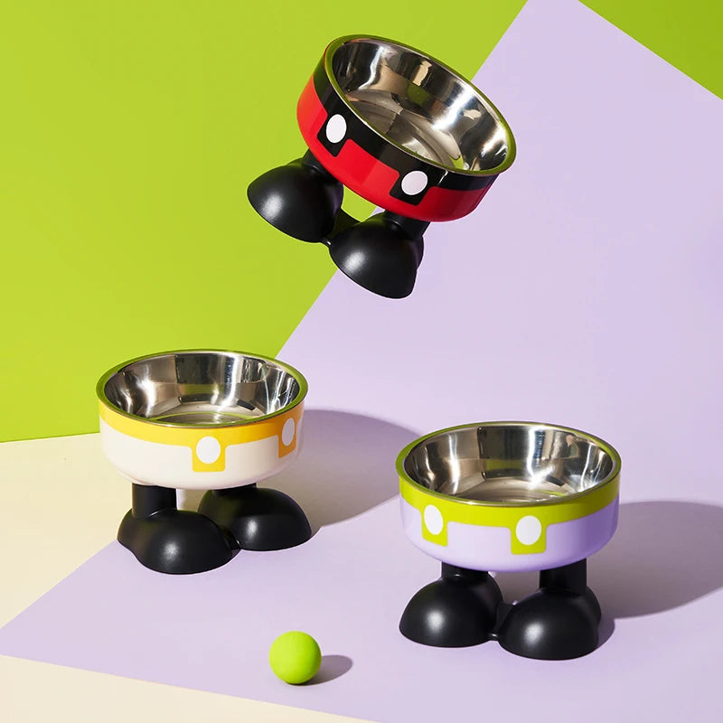 A set of three elevated stainless steel pet bowls in black and red with yellow accents, resting on a purple surface.