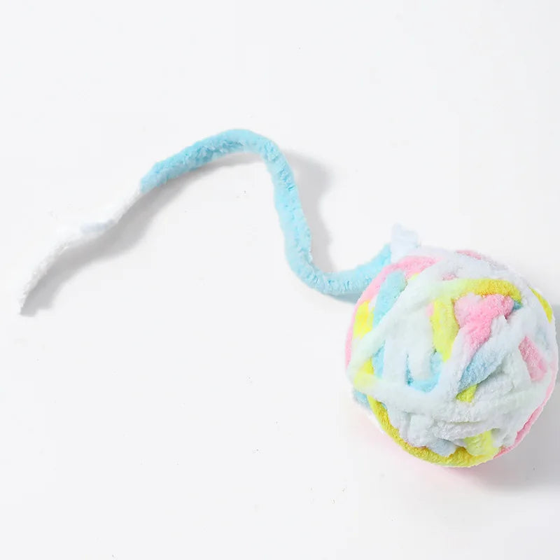 A soft plush cat toy ball with a light blue string and multicolored fluffy texture.