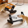 A ginger cat is interacting with an adjustable raised bowl for treats and tender, placed on a light wooden floor.