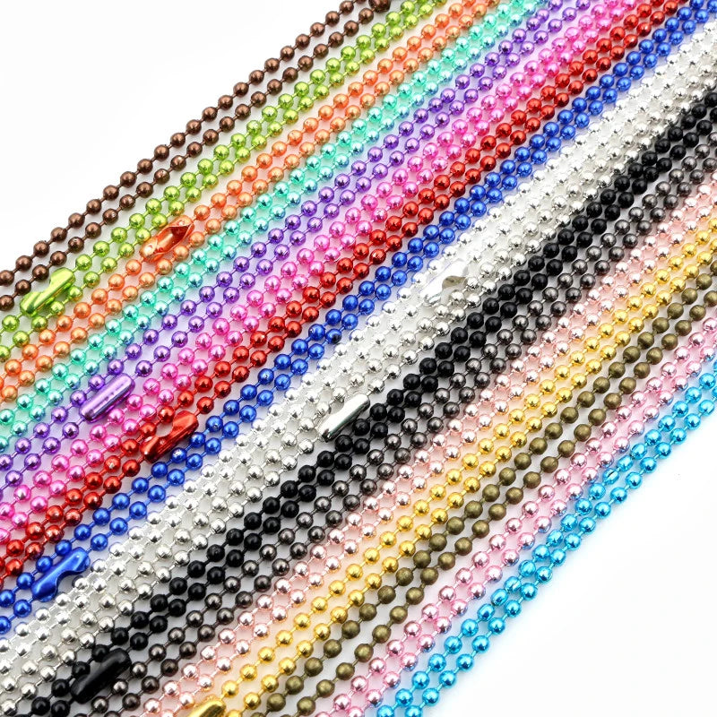A close-up of a multicolored ball necklace set featuring gold and silver plated beads.