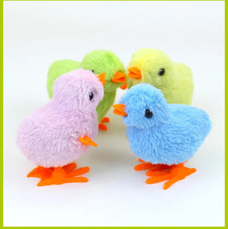 Three fluffy wind-up plush chicks in shades of green, yellow, and pink.