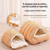 An orange and white checkered S-shaped cat bed with a plush fleece lining shown open.