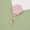 Pink leather paw print airtag keepsake attached to a gold keyring
