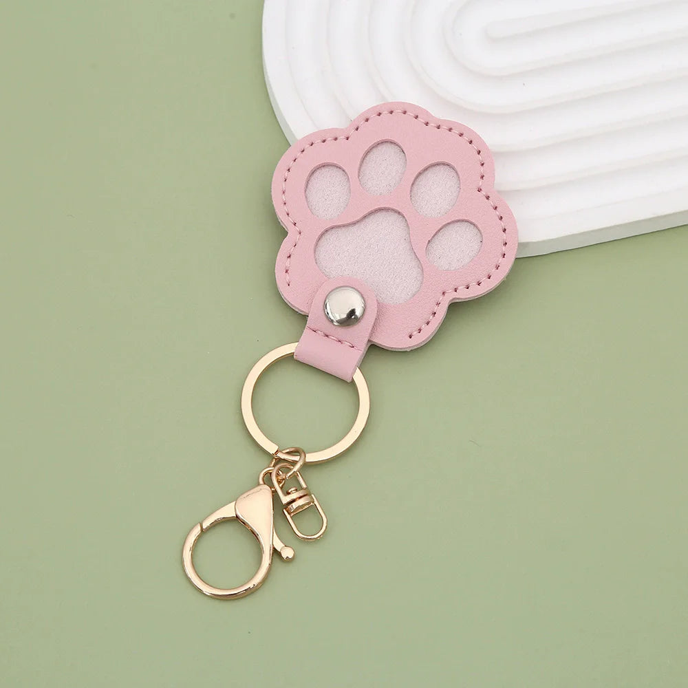 Pink leather paw print airtag keepsake attached to a gold keyring