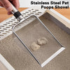 A hand is using a stainless steel pet poops shovel to scoop cat litter from a white plastic tray.