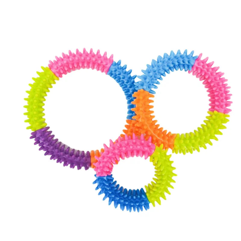 A set of colorful spiky ring dog chew toys for teeth cleaning and fetch play