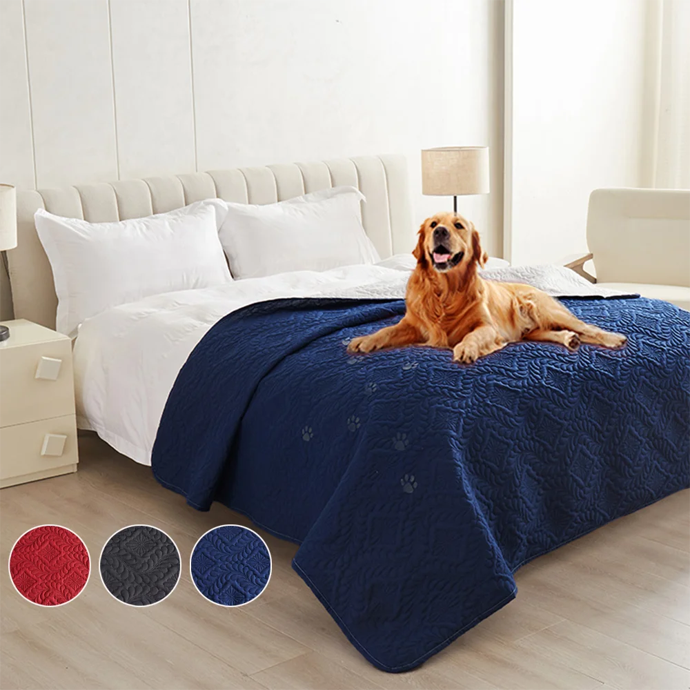 A dark blue waterproof pet bed cover protecting a white mattress and pillows in a bedroom setting.