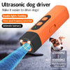 An orange ultrasonic dog driver device is shown emitting high frequency ultrasound waves.
