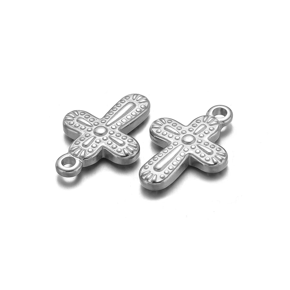 A pair of silver vintage cross charms used for DIY jewelry making.