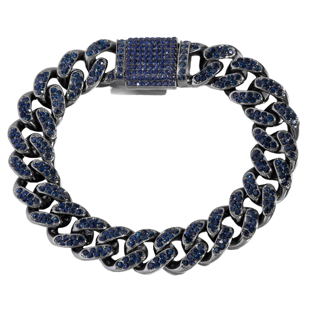 A close-up of a silver iced-out Cuban link bracelet featuring blue gemstones and a rectangular centerpiece.