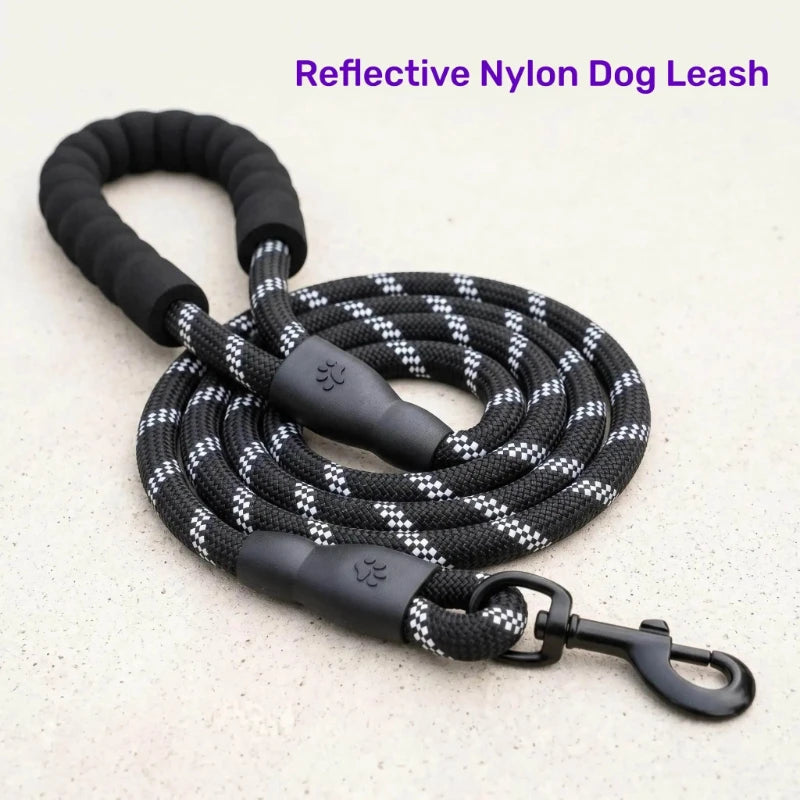 A black reflective nylon dog leash coiled on a light surface.
