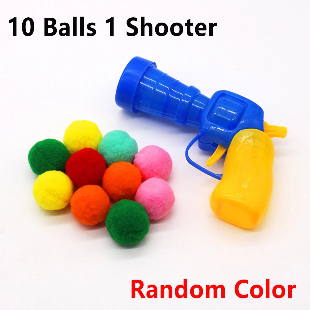 A blue plunger-style shooter toy gun is shown with ten soft plush balls of random colors, including yellow, green, red, and p