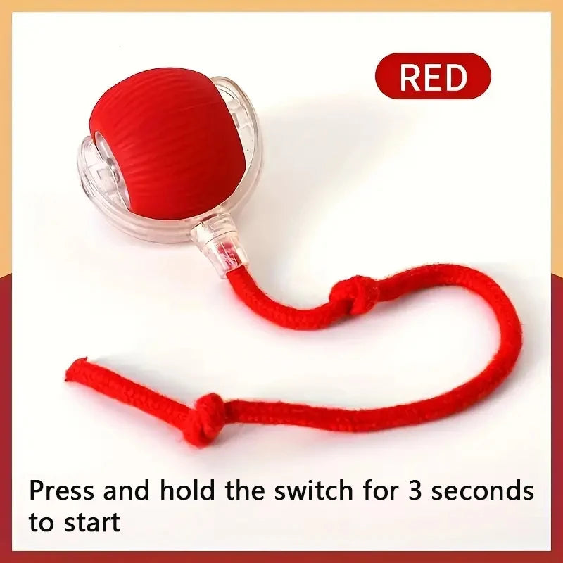A red interactive auto-roll cat ball with a faux mouse tail switch for starting.
