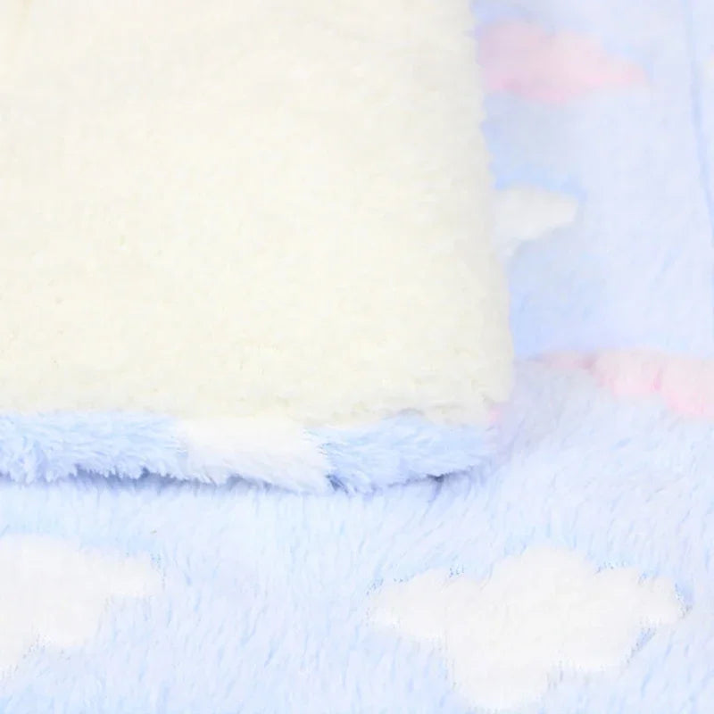 A white plush fleece pet blanket or bed mat with light blue and pink cloud patterns.