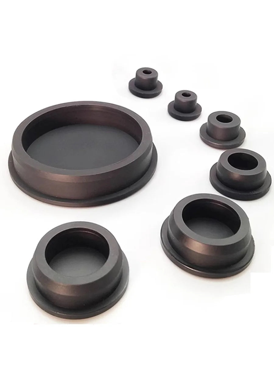 A set of dark silicone rubber hole plugs and seals for various applications.