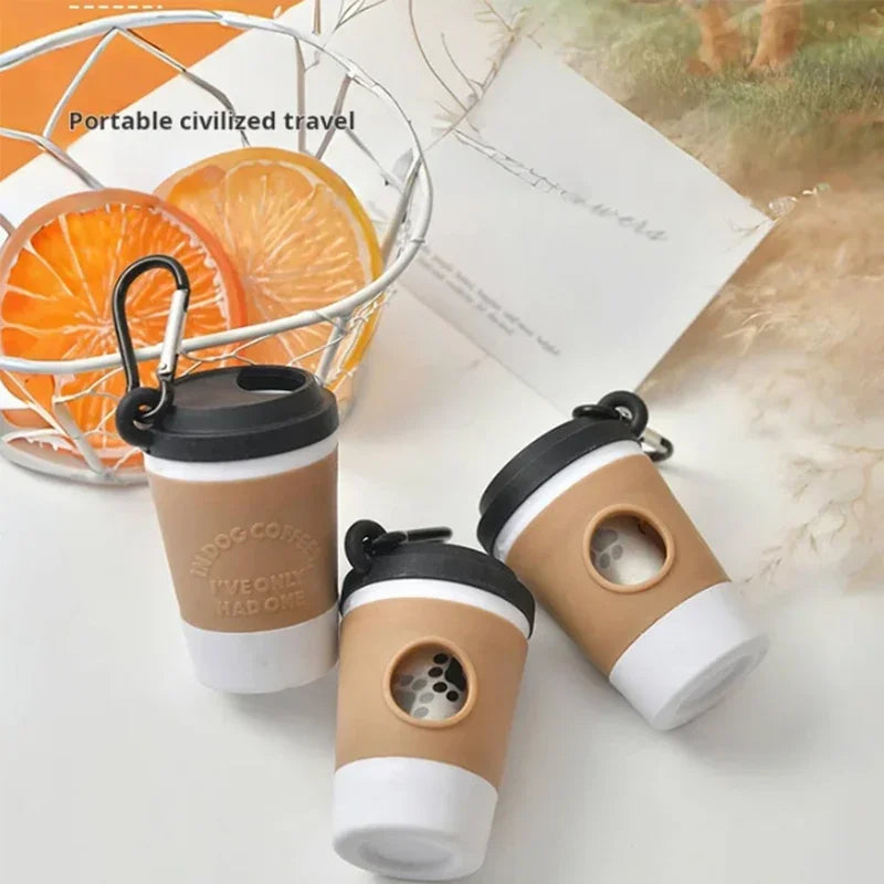Three disposable coffee cups in beige and white are displayed next to an orange fruit basket.