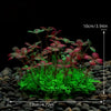 A set of four artificial aquarium plants with reddish-green leaves planted in dark gravel.