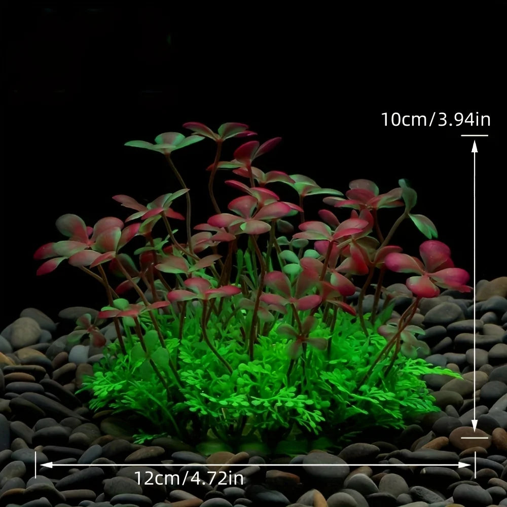 A set of four artificial aquarium plants with reddish-green leaves planted in dark gravel.
