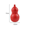 A bright red, rounded dog chew toy with a small protrusion and textured surface.