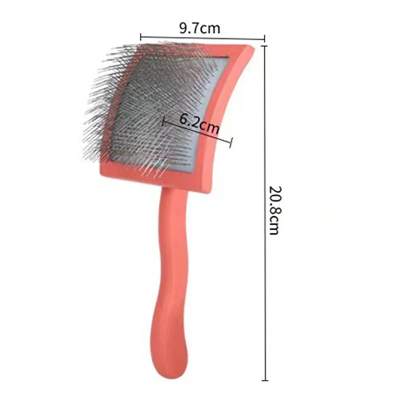 An ergonomic pet grooming rake with stainless steel teeth shown in a pink handle and gray bristles.