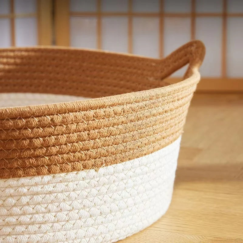 Handwoven rattan cat bed with a cotton rope edge, featuring natural brown and white textures.