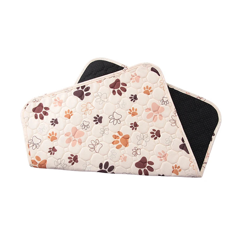 A set of washable non-slip dog training pads featuring a light pink quilted pattern with brown and cream paw prints.