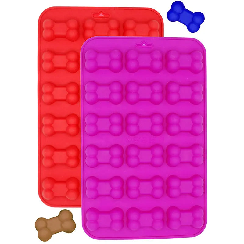 A set of silicone molds shaped like dog paws and bones in red and pink colors.