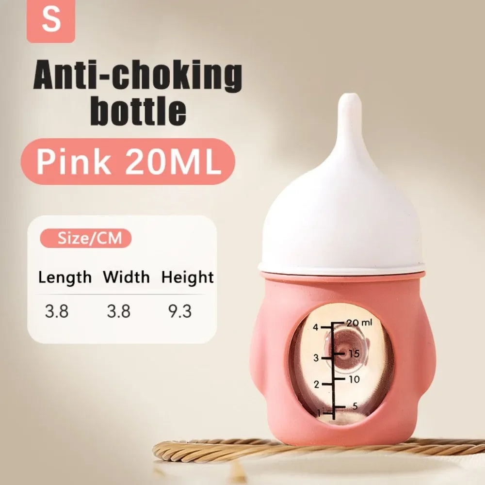 Pink 20ml silicone pet nursing bottle with anti-choking valve shown on a wooden surface