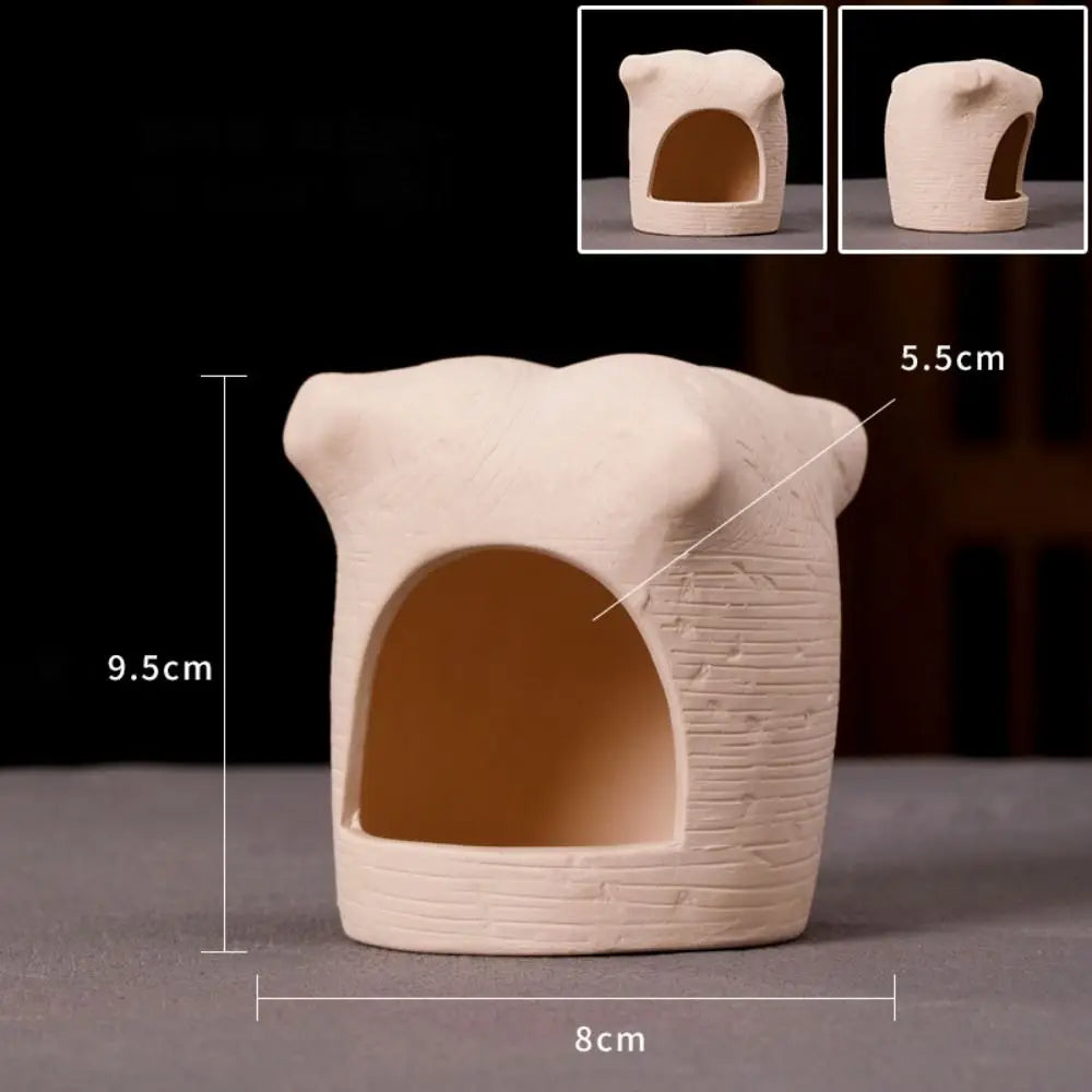 A beige ceramic aquarium shrimp hideaway cave with a rounded top and textured sides.