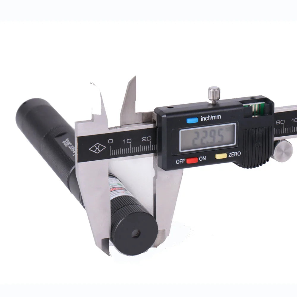 A black laser pointer pen with an inch/mm scale and a silver adjustable focus mechanism.