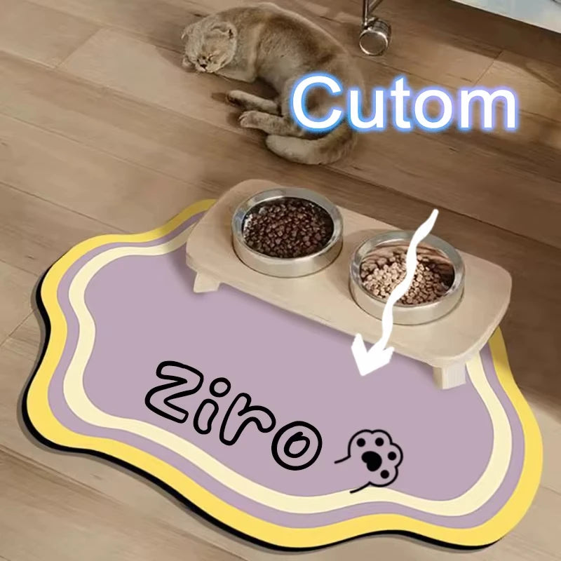 A pet feeding mat with a non-slip base and two bowls of food is shown on a wooden floor.
