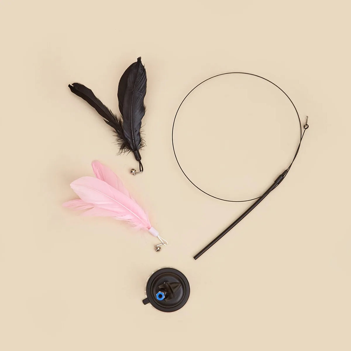 A black feather wand toy with a long line and a pink feather, along with a suction cup component.