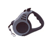 A gray and black automatic retractable dog leash for small pets with a handle.