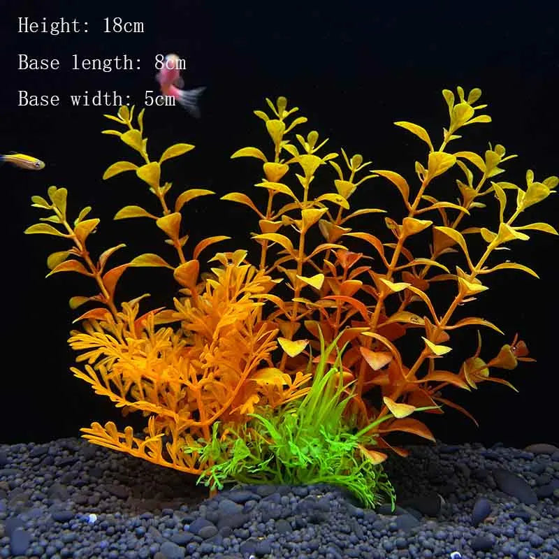 A vibrant artificial aquarium plant with yellow and orange foliage growing from a dark substrate.