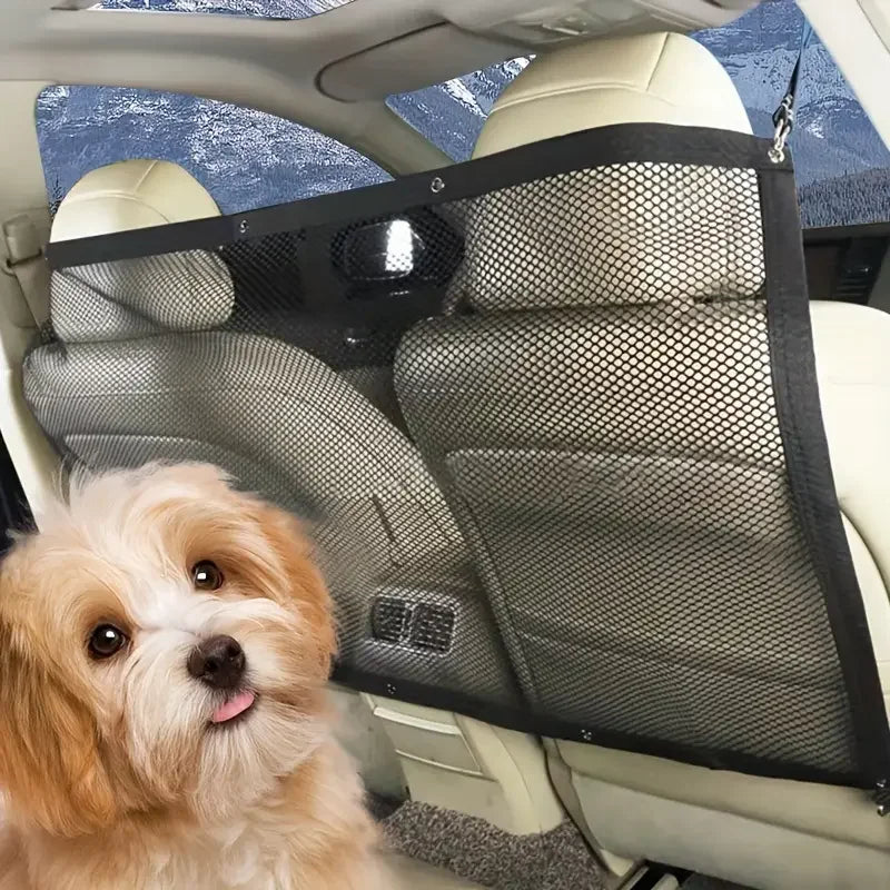 A fluffy golden dog looks out from inside a car with a black foldable pet barrier safety net installed on the seat.