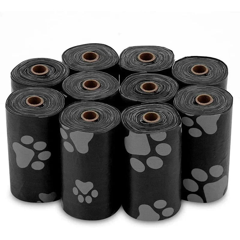 A set of black continuous roll dog poop bags in various gray paw print designs.