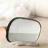 A pair of reusable 5-finger pet grooming gloves with a gray and white textured surface resting on a light surface.