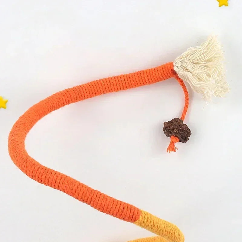 An orange rope teaser toy for cats with a fluffy white end and a small dark ball on a white background.