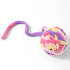 A soft plush cat toy ball with a purple and pink striped cord is shown against a white background.