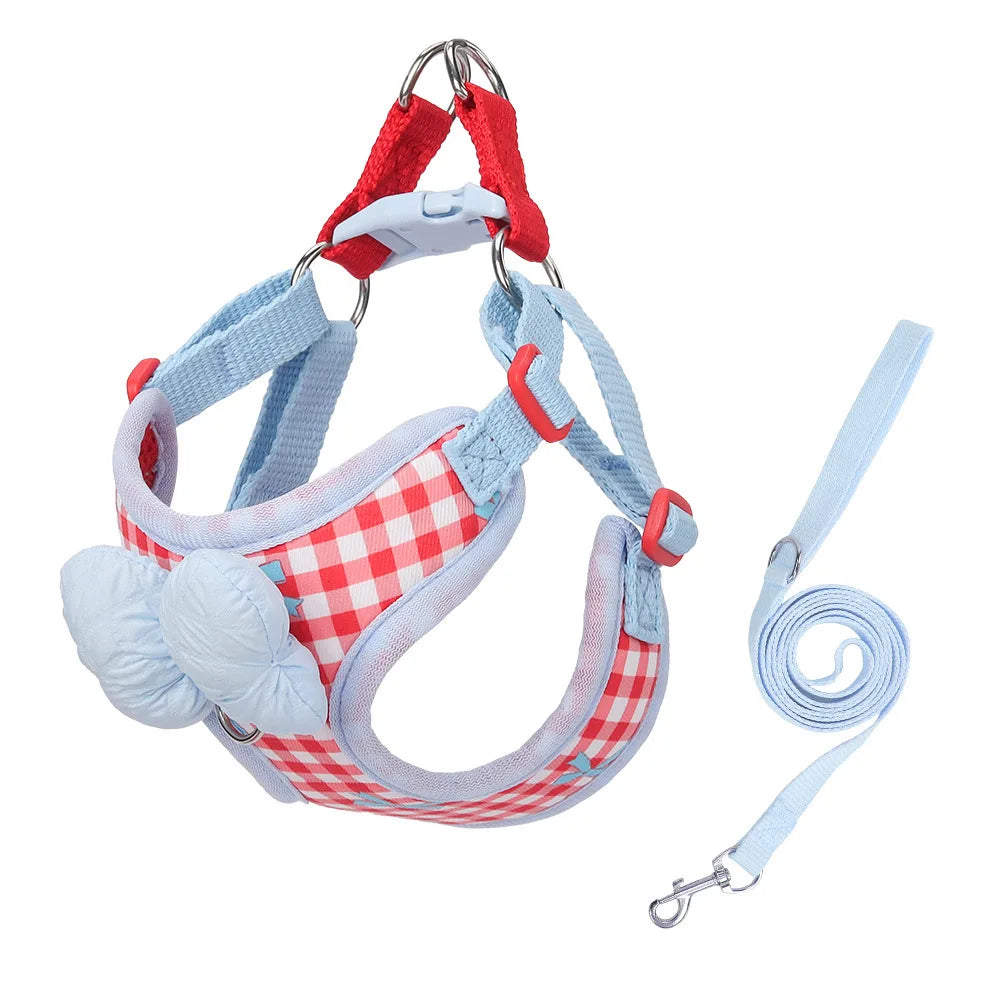Adjustable plaid dog harness with bow for small breeds featuring red and blue fabric.