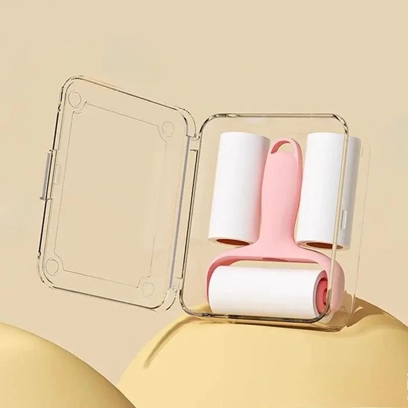 Clear plastic case holding a pink mini lint roller with replaceable adhesive paper rolls.
