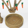 A natural grass carrot tree chew toy for rabbits and small pets with orange carrots hanging from a woven branch.